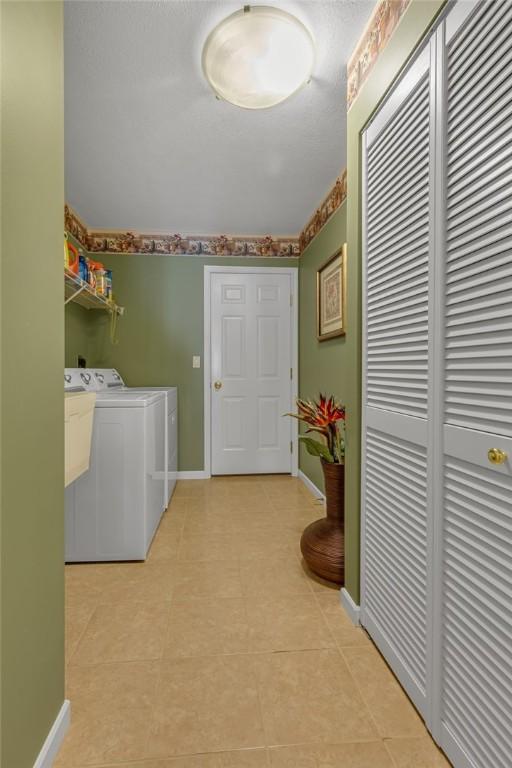 1101 Timberwood, Chippewa Twp, PA 15010 - washroom with washer and dryer and light tile patterned flooring