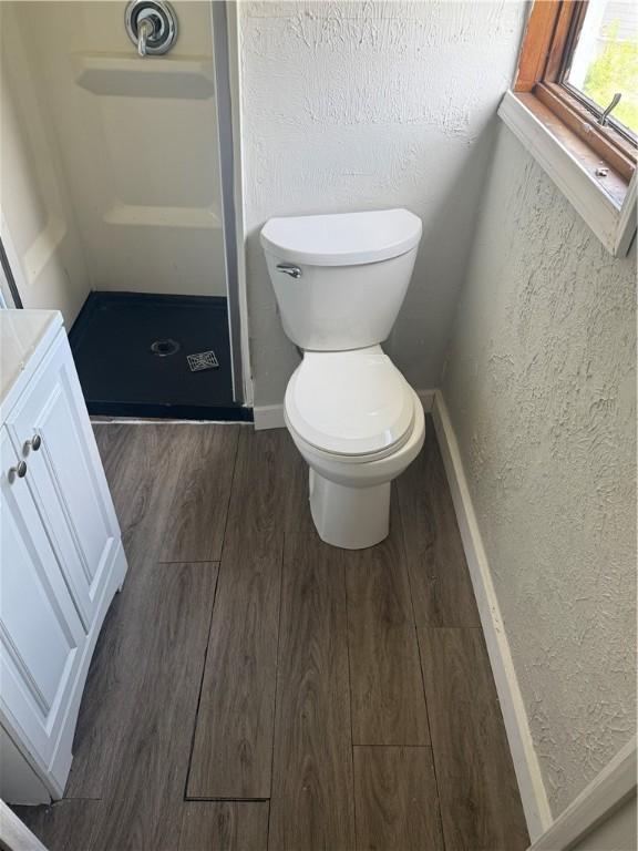965 Leeds, Monessen, PA 15062 - bathroom featuring wood finished floors, a shower stall, vanity, and a textured wall