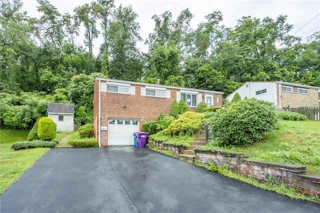 127 Mardi Gras Dr, Plum Boro, PA 15239 - ranch-style house with driveway, a garage, brick siding, a storage unit, and view of wooded area