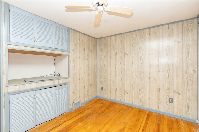 127 Mardi Gras Dr, Plum Boro, PA 15239 - spare room featuring wood finished floors, wooden walls, and ceiling fan