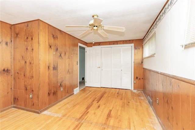 127 Mardi Gras Dr, Plum Boro, PA 15239 - unfurnished bedroom with wooden walls, wood finished floors, a closet, and ceiling fan