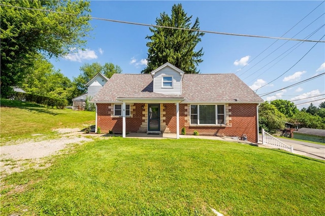 57 Welcome St, East Bethlehem, PA 15333 - cape cod-style house featuring brick siding, a front yard, and a shingled roof