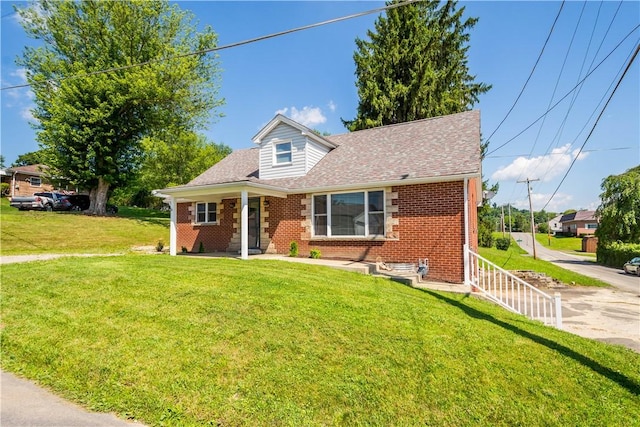 57 Welcome St, East Bethlehem, PA 15333 - view of front of house featuring brick siding, a front lawn, and roof with shingles