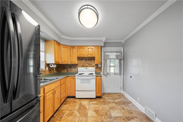 57 Welcome St, East Bethlehem, PA 15333 - kitchen with freestanding refrigerator, white electric range, backsplash, ornamental molding, and light stone finish floors