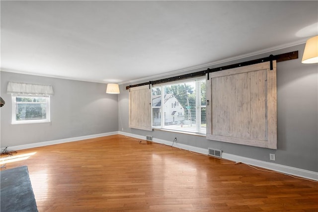57 Welcome St, East Bethlehem, PA 15333 - unfurnished room featuring a barn door and wood finished floors