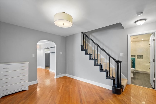 57 Welcome St, East Bethlehem, PA 15333 - staircase featuring arched walkways and wood finished floors