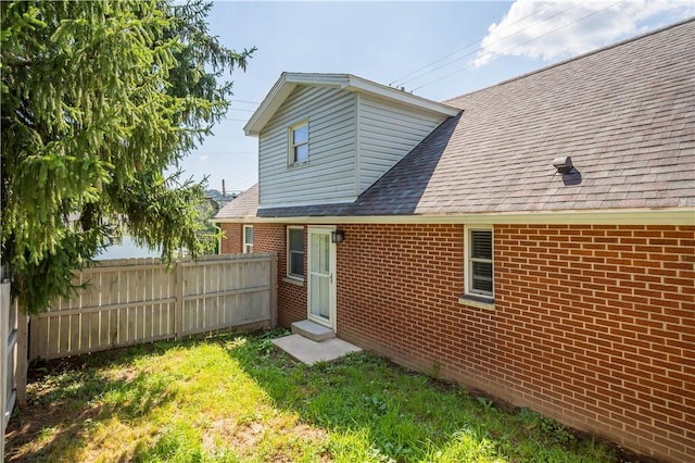 57 Welcome St, East Bethlehem, PA 15333 - rear view of property featuring brick siding and roof with shingles