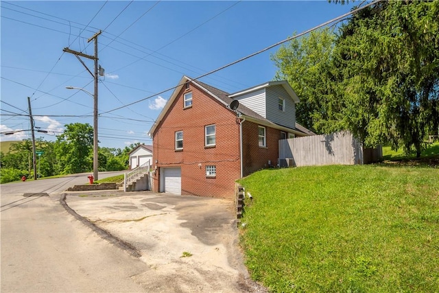 57 Welcome St, East Bethlehem, PA 15333 - view of side of property featuring a garage, driveway, and brick siding