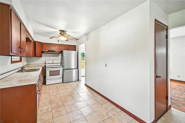 129 Shenango Park Rd, Pymatuning Twp, PA 16154 - kitchen featuring light countertops, freestanding refrigerator, electric stove, ceiling fan, and light tile patterned flooring