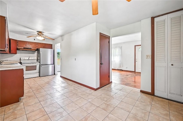 129 Shenango Park Rd, Pymatuning Twp, PA 16154 - kitchen with a ceiling fan, light tile patterned flooring, freestanding refrigerator, and white electric range