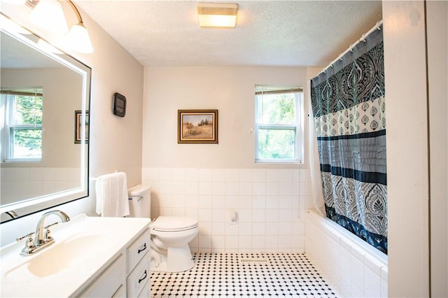 385 Wallace Run Rd, Big Beaver, PA 15010 - full bath featuring tile walls, vanity, plenty of natural light, a textured ceiling, and wainscoting