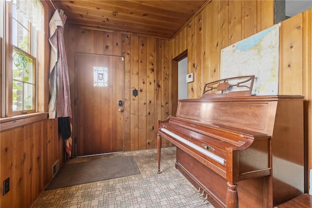 827 Beaver Rd, Ambridge, PA 15003 - entrance foyer with wooden ceiling, wooden walls, and tile patterned floors