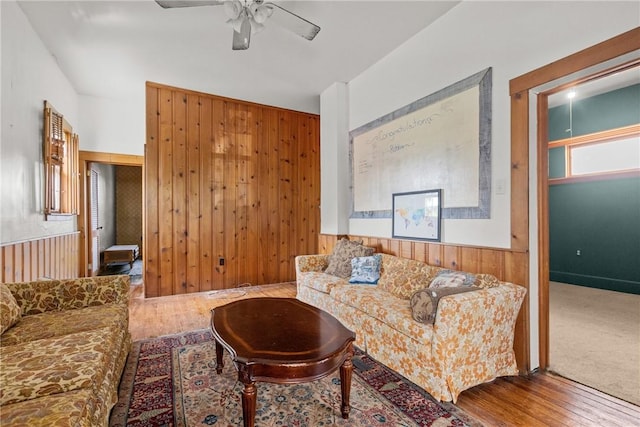 827 Beaver Rd, Ambridge, PA 15003 - living room with wood walls, a ceiling fan, wood finished floors, and a wainscoted wall