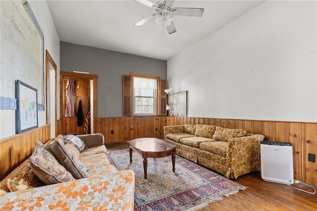 827 Beaver Rd, Ambridge, PA 15003 - living area featuring a wainscoted wall, wood walls, wood finished floors, and ceiling fan