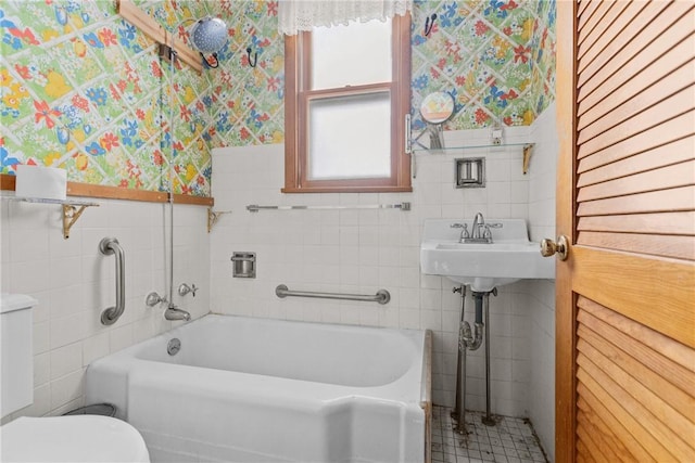 827 Beaver Rd, Ambridge, PA 15003 - bathroom with tile walls, a tub, wallpapered walls, and a wainscoted wall