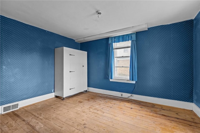 827 Beaver Rd, Ambridge, PA 15003 - spare room with wood-type flooring and wallpapered walls