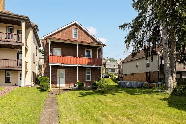 827 Beaver Rd, Ambridge, PA 15003 - rear view of property with brick siding, a yard, and a balcony