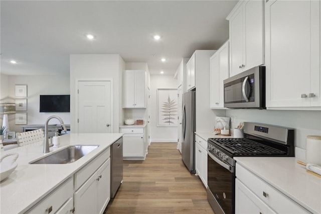 130 River Ridge Drive, Moon/Crescent Twp, PA 15108 - kitchen featuring appliances with stainless steel finishes, light wood-style flooring, white cabinets, light countertops, and recessed lighting