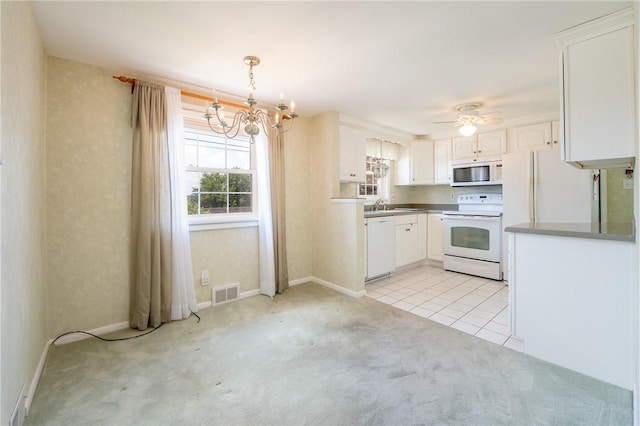 1936 Sylvan Ave, Latrobe, PA 15650 - kitchen featuring white appliances, a chandelier, white cabinetry, and light carpet