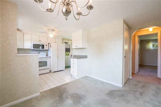 1936 Sylvan Ave, Latrobe, PA 15650 - kitchen featuring arched walkways, white cabinetry, light colored carpet, white appliances, and a chandelier