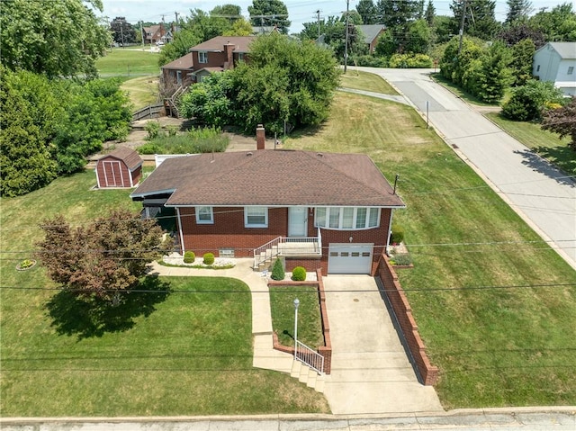 1936 Sylvan Ave, Latrobe, PA 15650 - view of front facade featuring concrete driveway, brick siding, an attached garage, and a front lawn