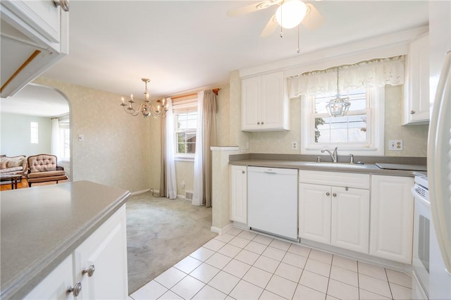 1936 Sylvan Ave, Latrobe, PA 15650 - kitchen with white appliances, a chandelier, light carpet, white cabinets, and arched walkways