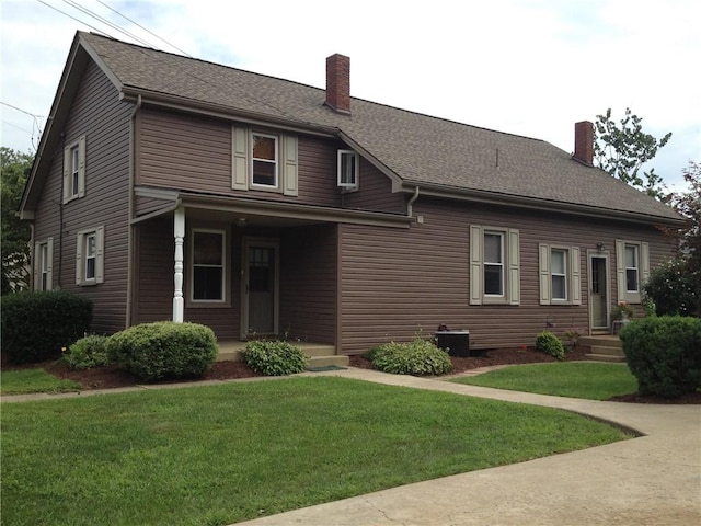 1216-1218 Clark St Unit 1216, White Oak, PA 15131 - view of front of house featuring a chimney, a front lawn, and roof with shingles