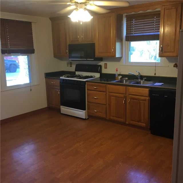 1216-1218 Clark St Unit 1216, White Oak, PA 15131 - kitchen featuring black appliances, dark countertops, healthy amount of natural light, and brown cabinetry