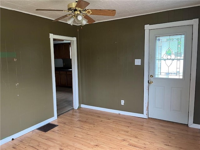 402 N 10th St, Apollo Boro, PA 15613 - entryway with light wood-type flooring, a ceiling fan, and wood walls