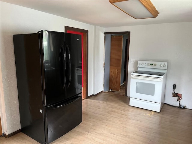 402 N 10th St, Apollo Boro, PA 15613 - kitchen featuring freestanding refrigerator, white range with electric stovetop, and light wood-style flooring