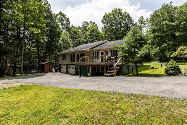178 Christopher, Christopher, PA 16640 - view of front of house featuring a storage shed, driveway, a garage, a wooden deck, and a front lawn
