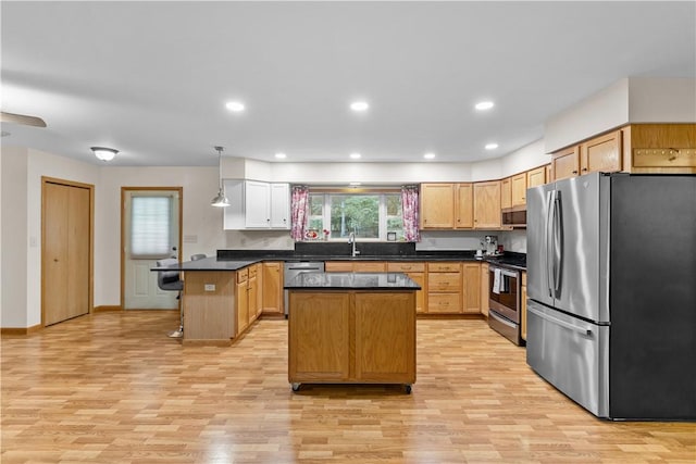 178 Christopher, Christopher, PA 16640 - kitchen with stainless steel appliances, light wood finished floors, dark countertops, a peninsula, and recessed lighting