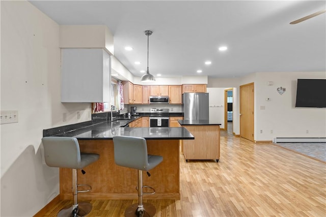 178 Christopher, Christopher, PA 16640 - kitchen featuring a peninsula, appliances with stainless steel finishes, dark countertops, light wood finished floors, and recessed lighting