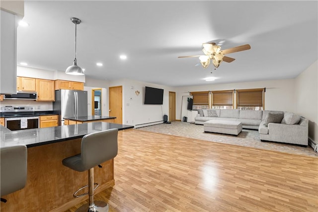 178 Christopher, Christopher, PA 16640 - kitchen featuring dark countertops, appliances with stainless steel finishes, light wood-style floors, a kitchen bar, and ceiling fan