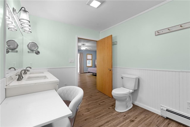 178 Christopher, Christopher, PA 16640 - bathroom featuring a wainscoted wall, a baseboard heating unit, wood finished floors, vanity, and a ceiling fan