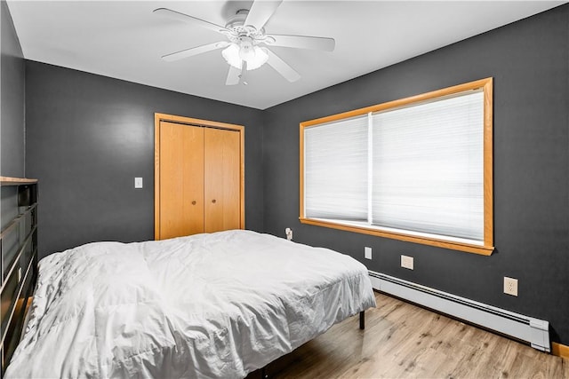 178 Christopher, Christopher, PA 16640 - bedroom featuring baseboard heating, wood finished floors, a closet, and ceiling fan