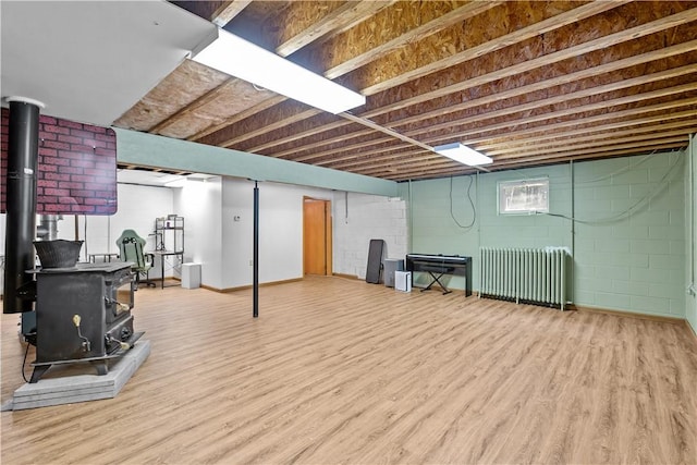 178 Christopher, Christopher, PA 16640 - basement featuring a wood stove, radiator, and wood finished floors