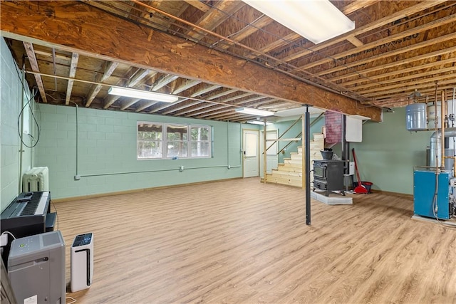 178 Christopher, Christopher, PA 16640 - basement featuring wood finished floors, stairway, concrete block wall, and a heating unit
