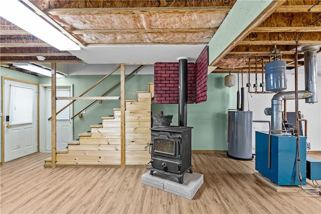 178 Christopher, Christopher, PA 16640 - below grade area with a wood stove, wood finished floors, water heater, and stairway