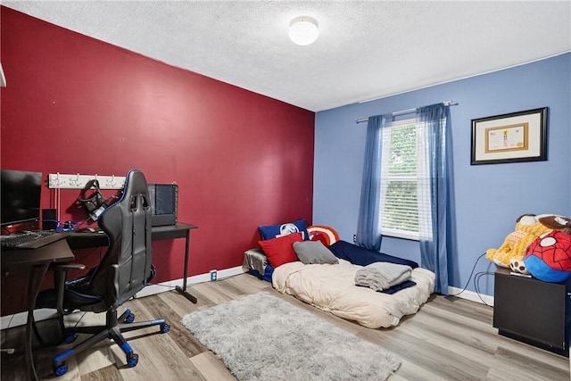 847 Sunset Cir, Cranberry Twp, PA 16066 - bedroom with a textured ceiling, wood finished floors, and an office area