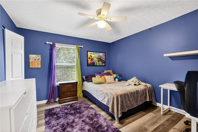847 Sunset Cir, Cranberry Twp, PA 16066 - bedroom with wood finished floors, ceiling fan, and a textured ceiling