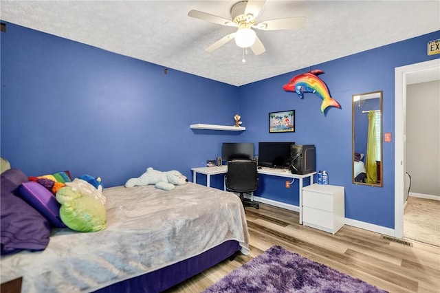 847 Sunset Cir, Cranberry Twp, PA 16066 - bedroom featuring wood finished floors, an office area, ceiling fan, and a textured ceiling