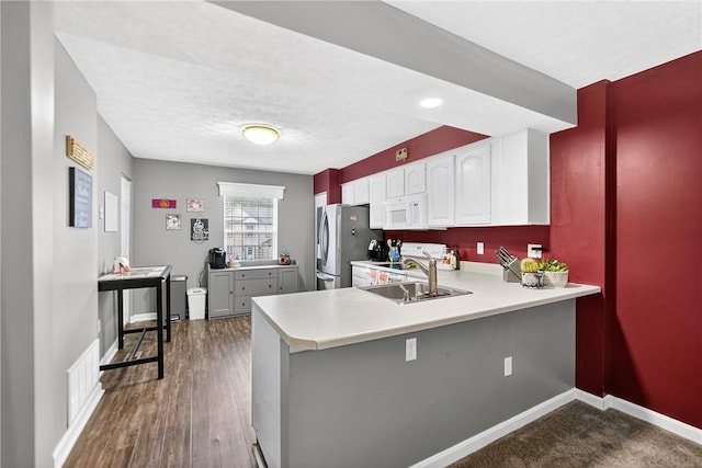 847 Sunset Cir, Cranberry Twp, PA 16066 - kitchen with light countertops, range, white cabinets, and a peninsula
