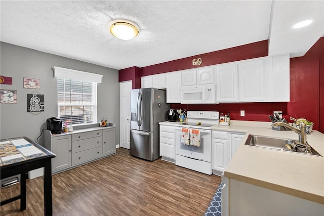 847 Sunset Cir, Cranberry Twp, PA 16066 - kitchen with white appliances, dark wood-type flooring, light countertops, white cabinetry, and a textured ceiling