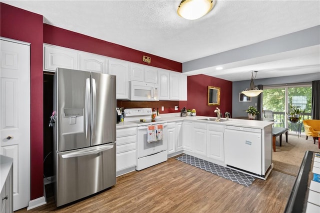 847 Sunset Cir, Cranberry Twp, PA 16066 - kitchen with white appliances, a peninsula, wood finished floors, white cabinetry, and a textured ceiling