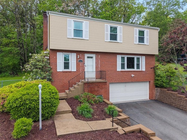215 E Edgewood Dr, Peters Twp, PA 15317 - colonial inspired home featuring a garage, asphalt driveway, and brick siding