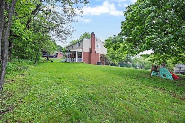 215 E Edgewood Dr, Peters Twp, PA 15317 - view of grassy yard with a playground and a sunroom