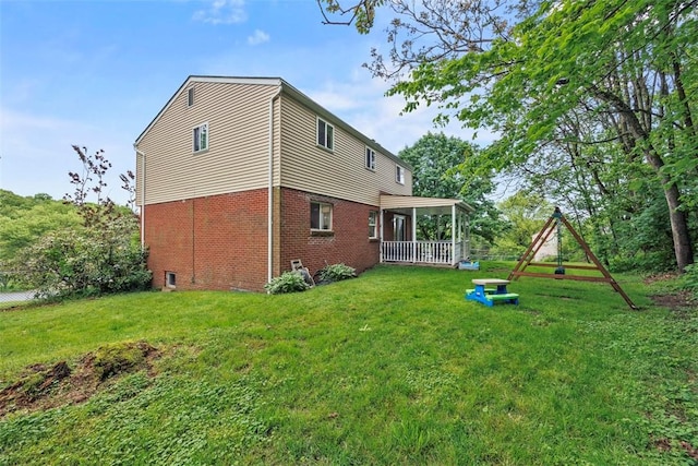 215 E Edgewood Dr, Peters Twp, PA 15317 - back of house featuring a lawn and brick siding