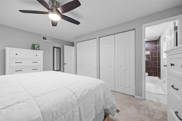 215 E Edgewood Dr, Peters Twp, PA 15317 - bedroom with multiple closets, light carpet, connected bathroom, and ceiling fan