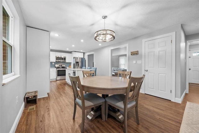 215 E Edgewood Dr, Peters Twp, PA 15317 - dining space featuring wood finished floors, a chandelier, and recessed lighting